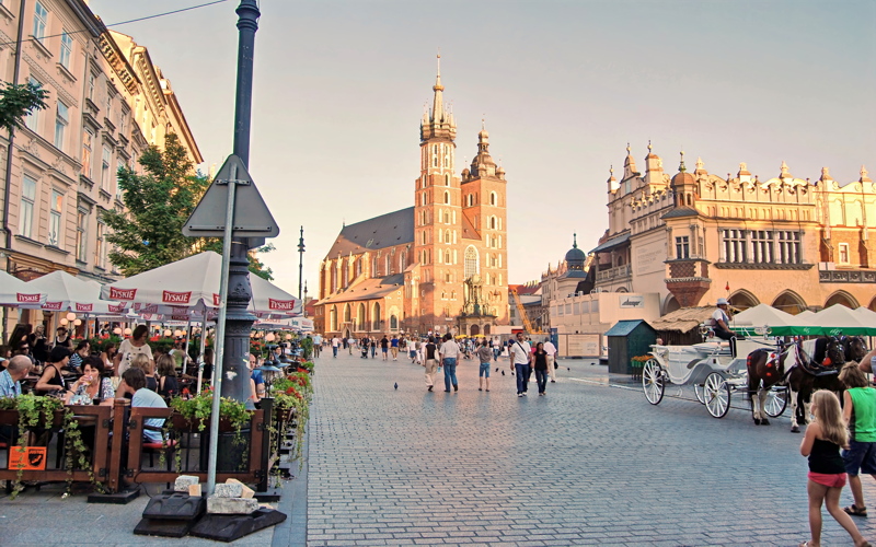 5 - The vibrant Main Market Square in Kraków, Poland, featuring the iconic Gothic spires of St. Mary's Basilica in the background